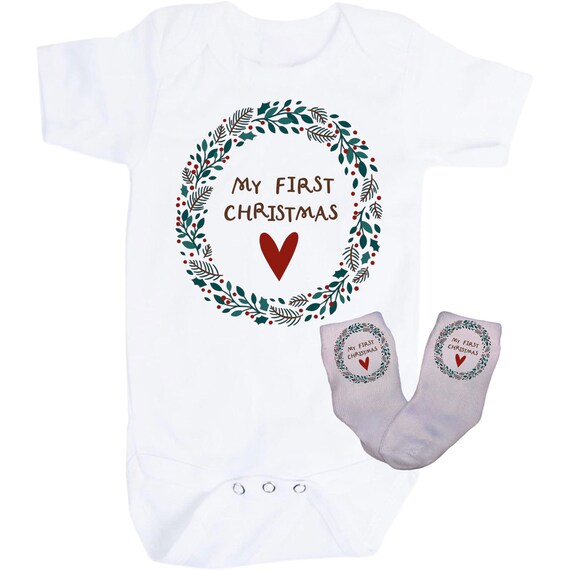 First Christmas Baby Bodysuit with Option to add Socks and No Scratch Mittens. Size 0-3 Months to 24 Months. EXCLUSIVELY FOUND HeRe!