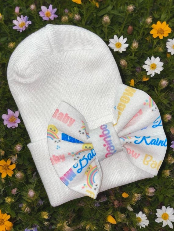 Rainbow Baby Bow Newborn Hat. Perfect for the arrival of your Rainbow Baby Girl. White hat with rainbow baby bow as pictured.