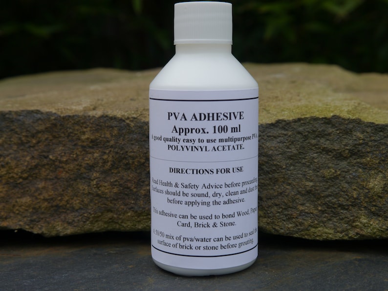 May include: A white bottle of PVA adhesive with a label that reads "PVA Adhesive Approx. 100 ml A good quality easy to use multipurpose PVA POLYVINYL ACETATE. DIRECTIONS FOR USE Read Health & Safety Advice before proceeding. Surfaces should be sound, dry, clean and dust free before applying the adhesive. This adhesive can be used to bond Wood, Paper, Card, Brick & Stone. A 50/50 mix of pva/water can be used to seal the surface of brick or stone before grouting."