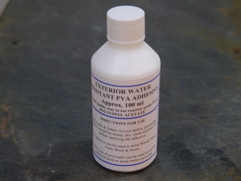 May include: A white plastic bottle of exterior water resistant PVA adhesive. The bottle is labeled with the text "Exterior Water Resistant PVA Adhesive", "Approx. 100 ml", "Polyvinylacetate", and "Directions for Use".