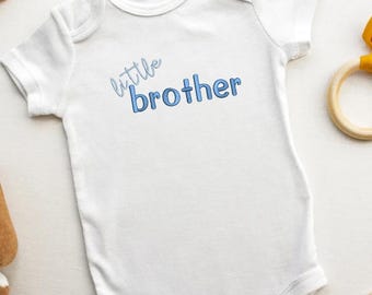 May include: White baby onesie with blue text that reads "little brother".