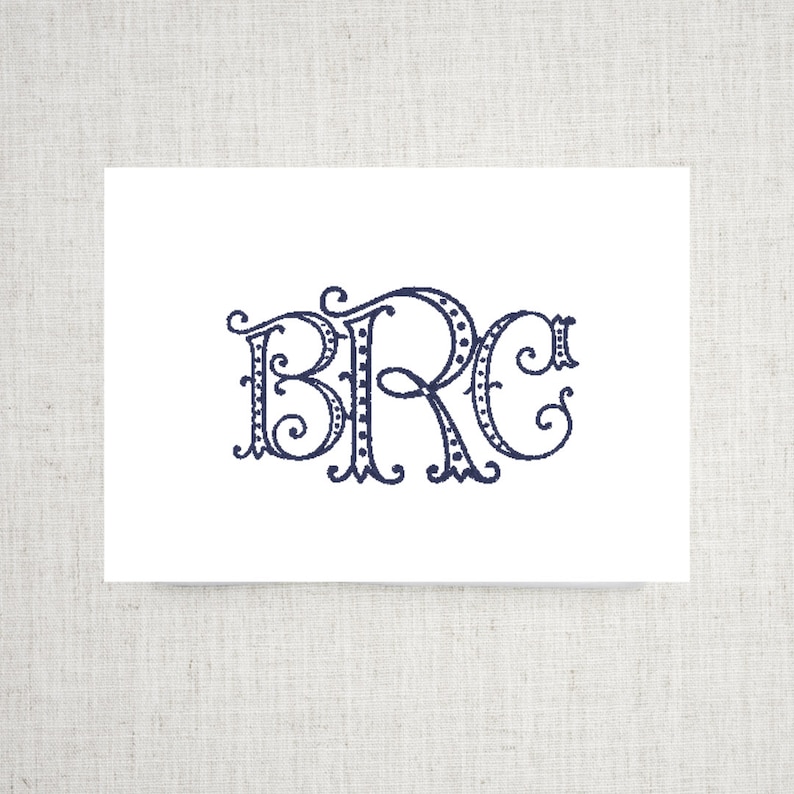 May include: A white card with a navy blue monogram of the letters "BRC" in a decorative script font with a dotted border.