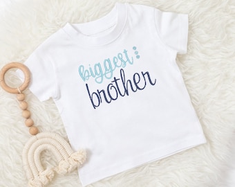 May include: White baby t-shirt with blue and light blue embroidered text that says "biggest brother".