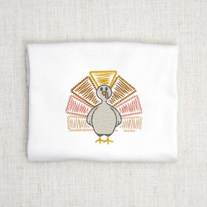 May include: Embroidered design of a gray turkey with a brown, orange, and pink patterned tail feathers.