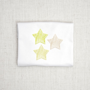 May include: A white fabric with three embroidered stars. Two of the stars are yellow and one is a light brown.