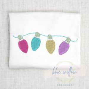 May include: Embroidered design of a string of colorful Christmas lights. The lights are pink, blue, yellow, and purple.
