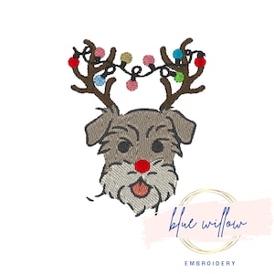 May include: A brown and gray dog with a red nose and reindeer antlers with colorful lights. The dog is wearing a red nose and has a happy expression. The text "blue willow embroidery" is at the bottom of the image.