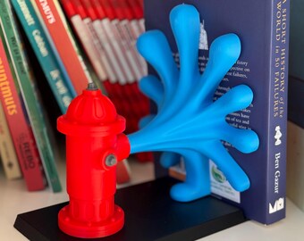 May include: A red fire hydrant bookend with a blue hand-shaped bookend holding a book titled "A Short History of the World in 50 Failures" by Ben Gazur.
