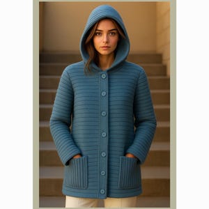 May include: A teal blue hooded coat with a button-up front and two front pockets. The coat has a ribbed texture and is worn by a person standing in front of a staircase. The coat is a stylish outerwear garment.