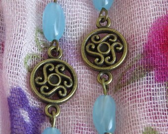 Bronze earrings with flourishes and blue accent by JosieCoccinelle