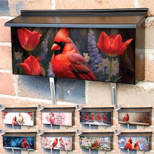 May include: A set of eight mailbox covers featuring different designs with red cardinals. The designs include cardinals in a garden setting, cardinals in a snowy landscape, and cardinals in a woodland setting. The mailbox covers are made of durable metal and are designed to fit standard-sized mailboxes.