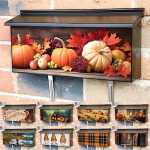 May include: A black mailbox with a fall-themed design featuring pumpkins, grapes, and autumn leaves. The mailbox has a wooden background and is decorated with a variety of fall colors, including orange, red, and brown.