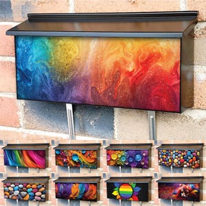 May include: A black metal mailbox with a colourful abstract design. The mailbox is rectangular in shape and has a flat top. The design features swirls of blue, green, yellow, orange, and red.