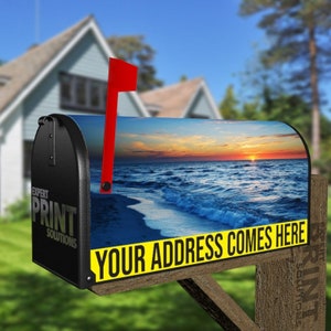 May include: Black mailbox with a sunset beach scene. The mailbox has a red flag and the text "YOUR ADDRESS COMES HERE" in yellow. The side of the mailbox has the text "EXPERT PRINT SOLUTIONS" in white.