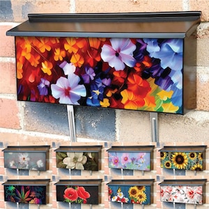 May include: A black metal mailbox with a variety of colorful floral designs. The mailbox has a rectangular shape and is mounted on a brick wall. The floral designs include red, orange, yellow, purple, and blue flowers.