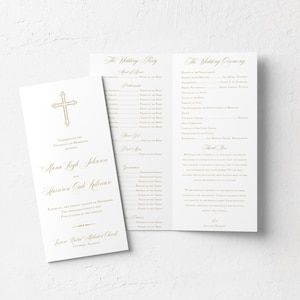 May include: A wedding ceremony program with a gold cross on the front cover. The program lists the order of events for the ceremony and reception. The couple's names are printed on the front: "Alana Leigh Johnson and Harrison Cade Holloman".