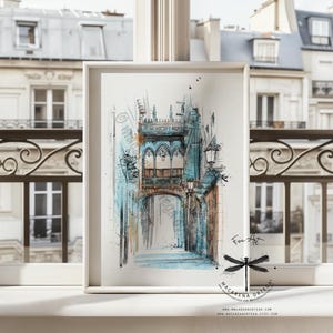 May include: Watercolor painting of a European street scene in shades of blue, brown, and white. The artwork depicts an arched doorway and architectural details. The framed print is displayed on a windowsill.