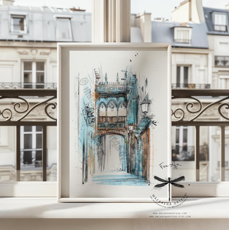 May include: Watercolor painting of a European street scene in shades of blue, brown, and white. The artwork depicts an arched doorway and architectural details. The framed print is displayed on a windowsill.
