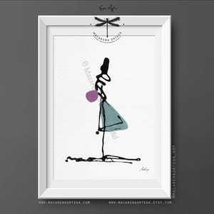 May include: Abstract art print in a white frame. The artwork features a minimalist figure with black ink lines, a purple sphere, and a teal triangle. The artist's signature is at the bottom. The frame has the artist's name and website.