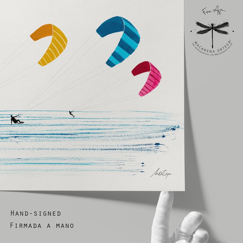 May include: Fine art print featuring three colorful kites in the sky over the ocean. The kites are yellow, blue, and pink. Two figures are kitesurfing. The print is hand-signed by the artist.