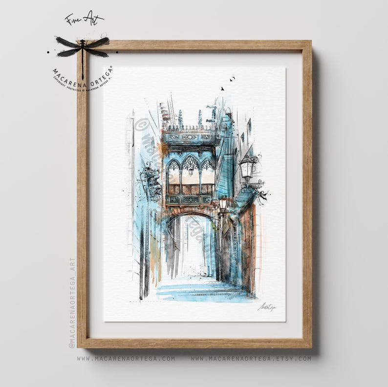 May include: Watercolor painting of an arched architectural structure in shades of blue, brown, and white, framed in a wooden frame. The artwork features a detailed depiction of a building with arched windows and street lamps, with the text "Fine Art" and the artist's name.