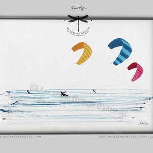 May include: Watercolor painting of kitesurfers on the water. Three colorful kites in yellow, blue, and pink are in the sky. The artwork is signed and framed, with the artist's name and website at the bottom.