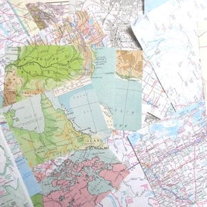 May include: A collage of old maps, overlapping each other. The maps display a variety of colours, including green, blue, pink, and beige, representing different geographical areas. Some maps show coastlines and land features.