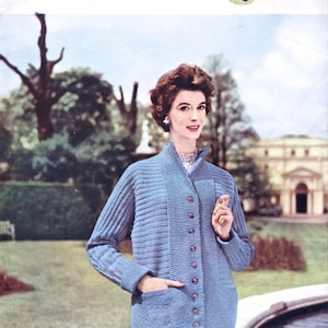 May include: A blue knitted cardigan with a button-up front and pockets. The cardigan is being modeled by a woman in a garden setting. The text "LAVENDA HAND KNIT" is at the top of the image. The text "30 OZS LAVENDA DOUBLE KNITTING 36 INS BUST SIXPENCE 494" is at the bottom of the image.