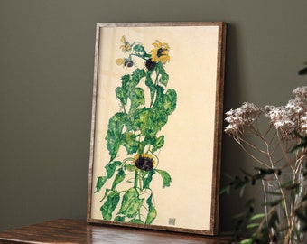 May include: A framed print of a botanical illustration of sunflowers with green leaves and yellow petals. The print is on a cream-colored background and is framed in a brown wood frame.