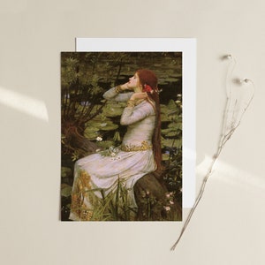 May include: A painting of a woman with long red hair sitting on a tree branch in a pond. She is wearing a white dress and has a red flower in her hair. The pond is filled with lily pads and there are green plants growing around the edges.