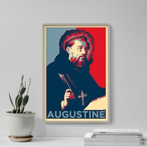 May include: A framed poster with a pop art style portrait of a man with a beard, holding a quill and wearing a cross. The background is split into red, blue, and yellow sections, with the name "AUGUSTINE" at the bottom.