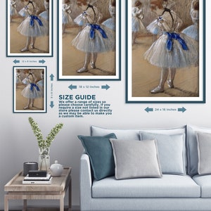May include: A pastel drawing of a young ballerina in a white tutu with a blue ribbon. The ballerina is standing in a dance studio with other dancers in the background. The drawing is framed in a dark blue frame.
