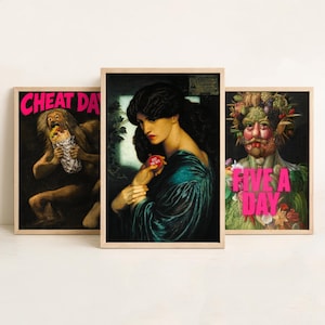 May include: Three framed art prints. The left print shows a figure eating a burrito with the text CHEAT DAY. The centre print depicts a person holding a red object with the text JUST ONE BITE. The right print shows a face made of produce with the text FIVE A DAY.