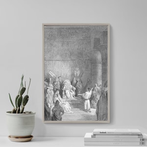 May include: A framed black and white print depicting a historical scene with figures in robes and headdresses. A central figure sits on a throne, surrounded by others. The artwork is detailed and appears to be an engraving or etching.