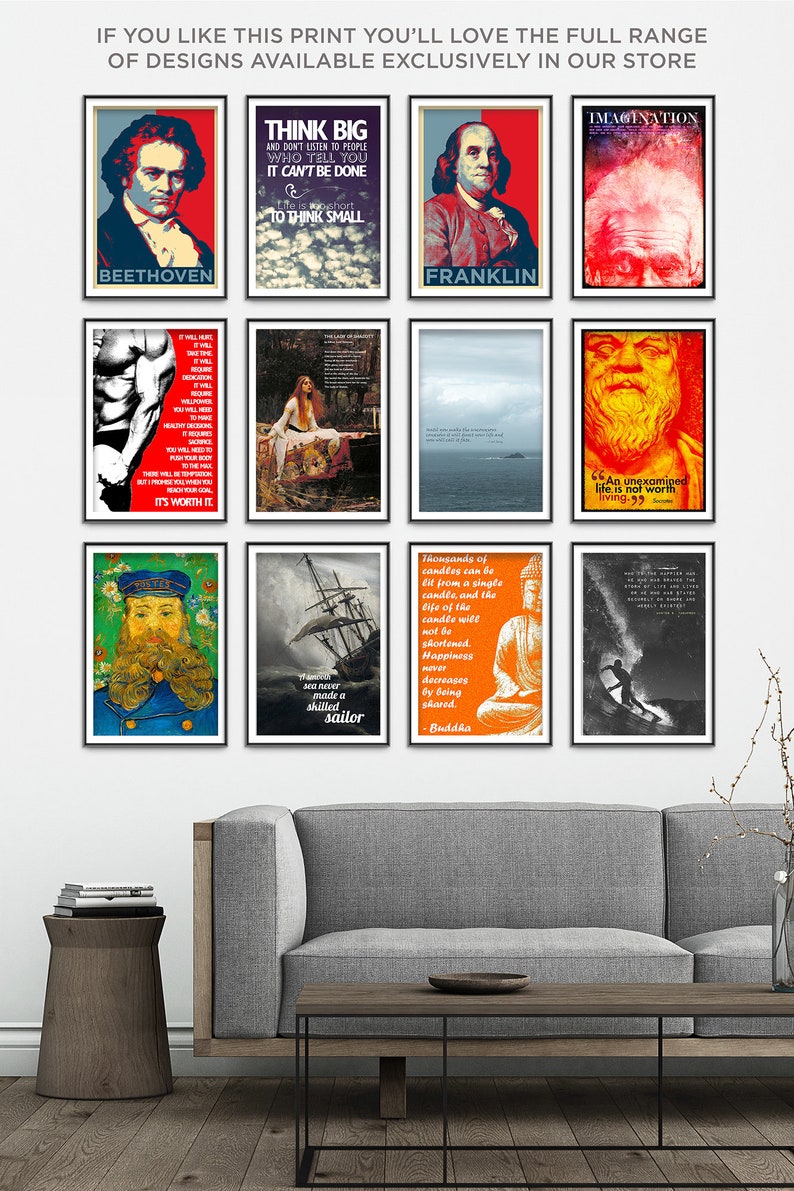 May include: A collage of nine framed posters with inspirational quotes and images. The posters are hung on a white wall above a gray couch and a wooden coffee table. The posters feature images of Beethoven, Franklin, a surfer, a ship, a muscle man, a woman in a field, a man with a beard, and a Buddha.