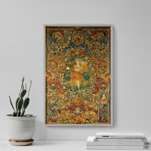 May include: A framed tapestry with a detailed floral and figure design. The artwork features a central figure surrounded by ornate flowers, leaves, and decorative elements in shades of gold, red, blue, and green. The frame is a light gray color.