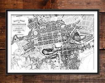 May include: A framed black and white map of Edinburgh, Scotland, from 1836. The map, titled "Kays Plan of Edinburgh," shows the city's layout with streets, buildings, and landmarks. The map is set against a dark wood background.