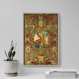 May include: A framed tapestry with a detailed floral and figurative design. The artwork features a central scene with figures, surrounded by ornate borders in shades of red, gold, green, and blue. The tapestry is displayed on a white wall.