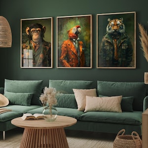 May include: Three rectangular wall art prints featuring anthropomorphic animals dressed in formal attire. The left print shows a chimpanzee in a patterned jacket, the center a parrot in an orange coat, and the right a tiger in a green jacket.