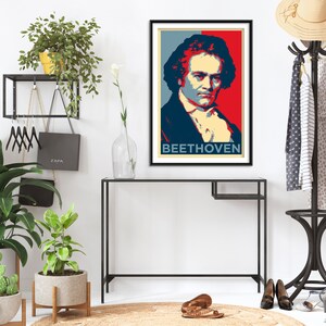 May include: A framed poster with a red, white, and blue color scheme featuring a portrait of Ludwig van Beethoven with the word "BEETHOVEN" printed below the portrait.