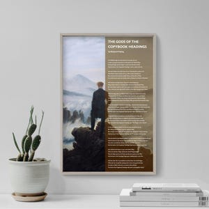 May include: A framed print titled "THE GODS OF THE COPYBOOK HEADINGS" by Rudyard Kipling. The artwork features a man standing on a rocky cliff, overlooking a misty landscape. A potted cactus sits to the left.