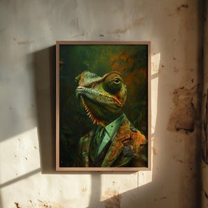 May include: A framed wall art print featuring a detailed illustration of a chameleon with a textured green and orange head, wearing a patterned brown suit jacket over a light green collared shirt and a dark tie, set against a dark jungle background.