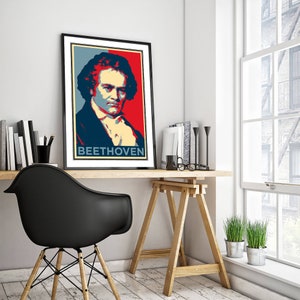 May include: A black framed poster with a red, white, and blue image of Ludwig van Beethoven. The poster has the text "BEETHOVEN" at the bottom.
