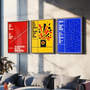 May include: Three framed rectangular wall art prints. The red print features a scatter plot and text: Every model is a simplification that gets something wrong. The useful ones are still worth keeping. The yellow print shows a black box with an eye and geometric shapes, with text: How often these machines do something I never saw coming. The blue print displays a network of lines and dots with text: Squeeze a dataset hard enough and it will tell you whatever you want to hear.
