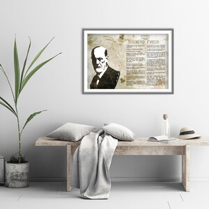 May include: A framed print of Sigmund Freud, a famous psychologist, with a quote about life and death. The print is in a vintage style with a brown and white color scheme.