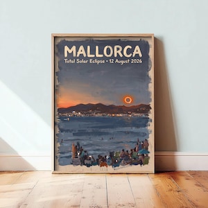 May include: A rectangular wall art print featuring a painted landscape of a beach in Mallorca during a total solar eclipse on 12 August 2026. The scene depicts a dark sky with a glowing solar ring, distant mountains, and a crowd gathered on the sand.
