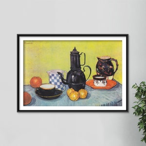 May include: A still life painting by Vincent van Gogh depicting a black teapot, two ceramic jugs, a cup and saucer, three oranges, and a blue tablecloth. The background is a yellow wall.