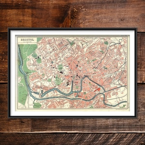 May include: Vintage map of Bristol, England, showing the city's streets and landmarks. The map is printed in shades of pink, green, and brown, with a blue river winding through the centre. The title "BRISTOL" is printed in bold at the top of the map.