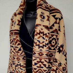 May include: A white ceramic mug with a black handle and the text "But First, Coffee" in a black, handwritten-style font. The mug is on a white surface.