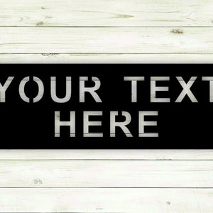 May include: Black metal sign with white stencil lettering that reads "YOUR TEXT HERE".